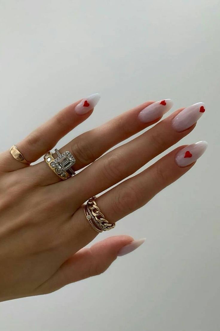 Elegant French Manicure with Soft Pink Base, Glossy White Tips, and Romantic Heart Accents.