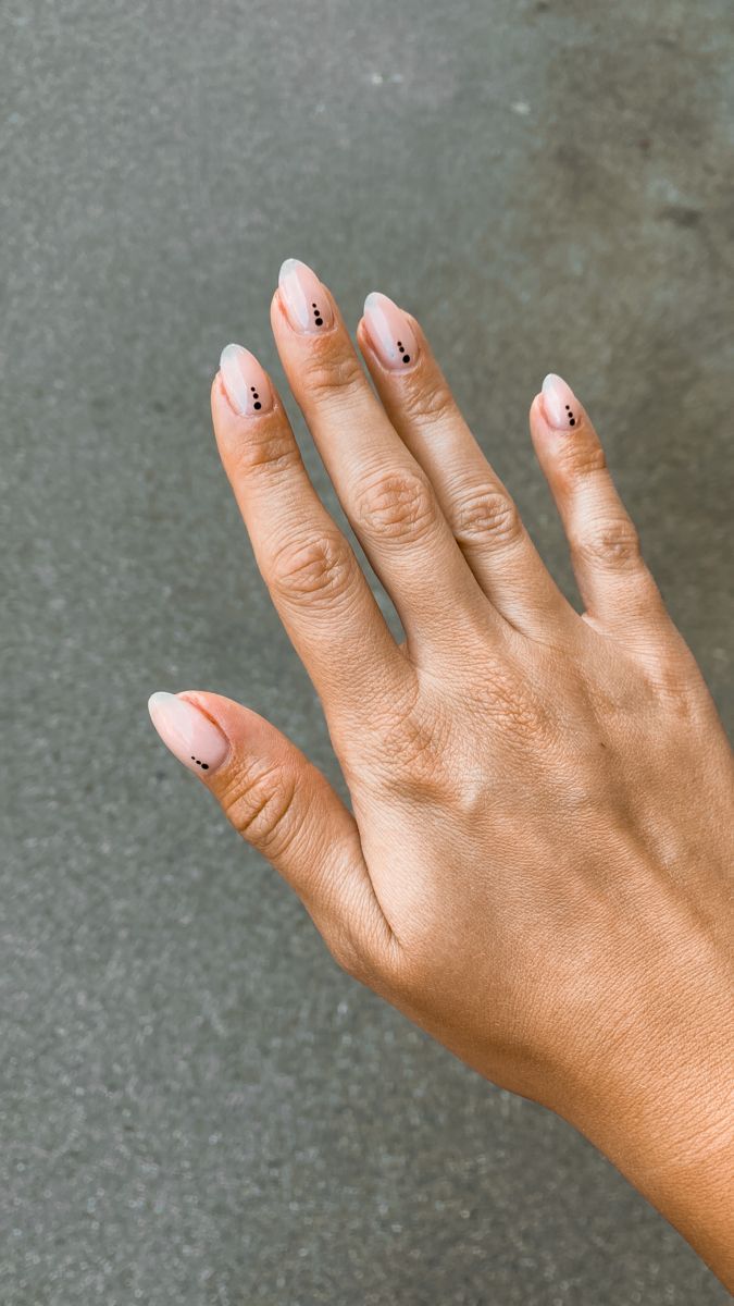 Stylish Minimalist Nail Design with Nude Base and Elegant Black Dots.