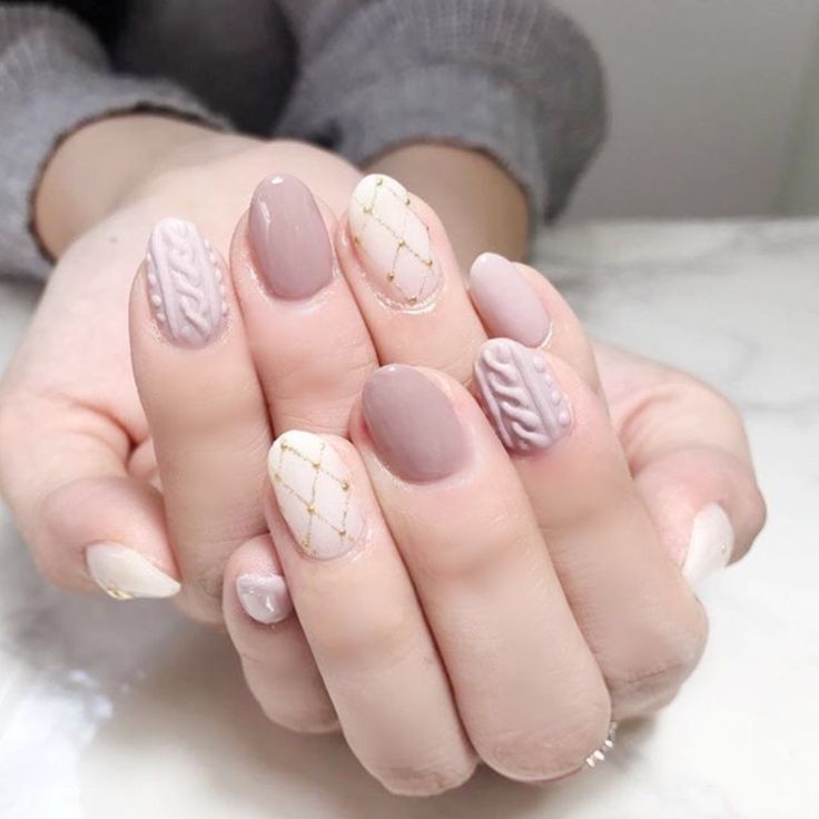 Sophisticated Nail Design: Muted Tones, Intricate Patterns, and Glitter Accents.