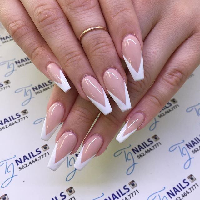 Sophisticated Almond-Shaped Nails with Striking Nude and White Design.