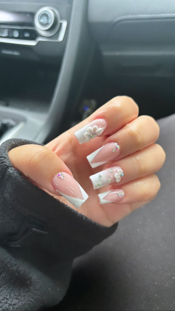 Chic Soft Pink and French Tip Nail Design with Floral Accents and Rhinestones