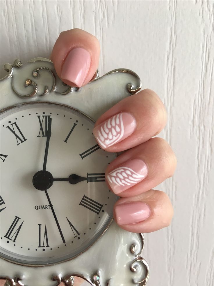 Whimsical Elegance: Delicate Pink Nails with White Wing Patterns.