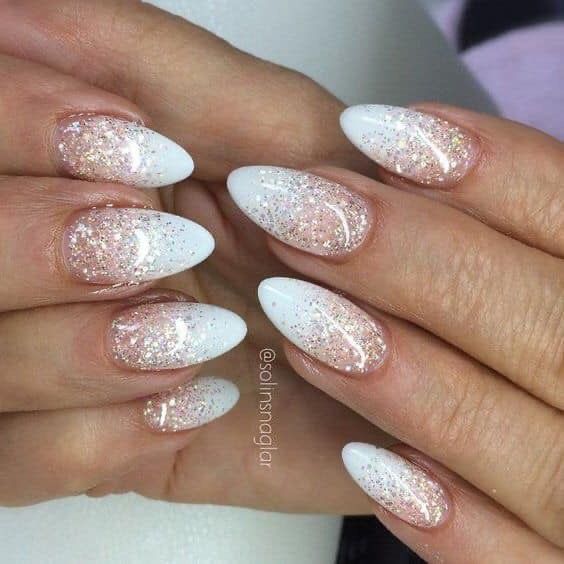 Elegant Almond-Shaped Nails: Chic White and Pale Pink Gradient with Glamorous Glitter Accents