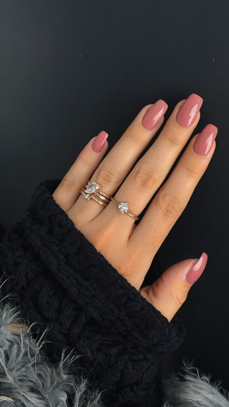 Sophisticated Soft Pink Nail Design Enhanced by Delicate Rings for a Chic Look.