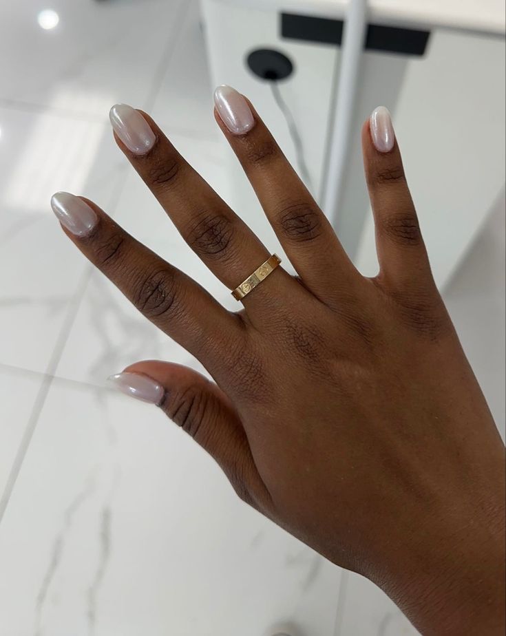 Sophisticated Almond-Shaped Nails with Sheer Nude Polish and Delicate Gold Accent.