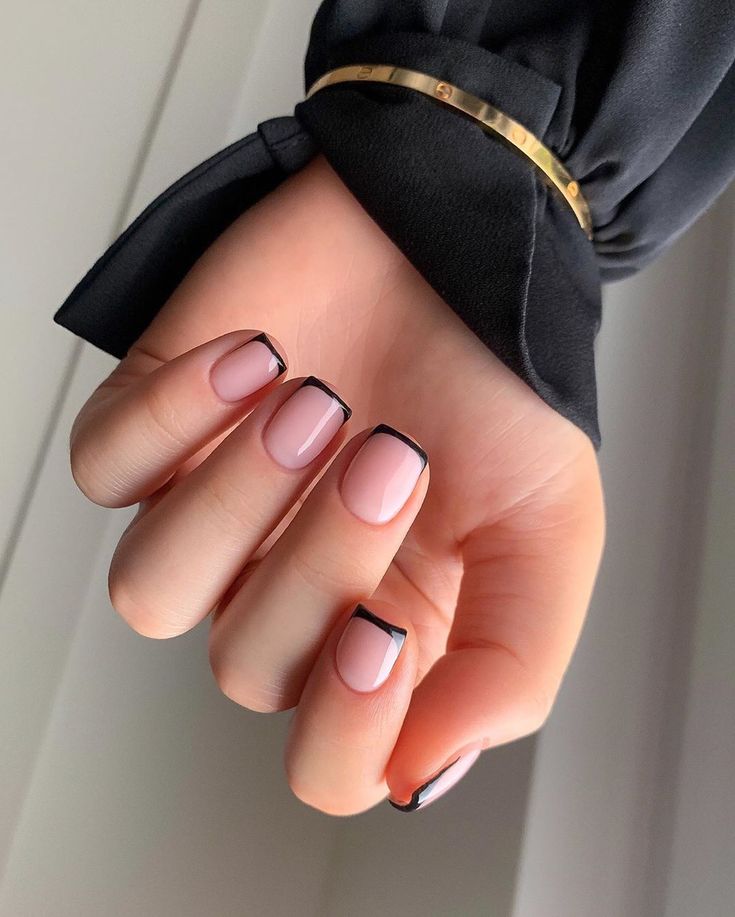 Chic Soft Pink Base with Sleek Black Tips: An Elegant and Playful Nail Design.