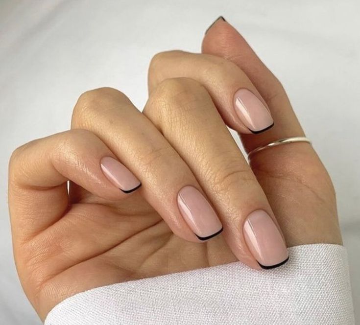 Sophisticated Elegant Nail Design: Soft Nude Base with Sleek Black Tips