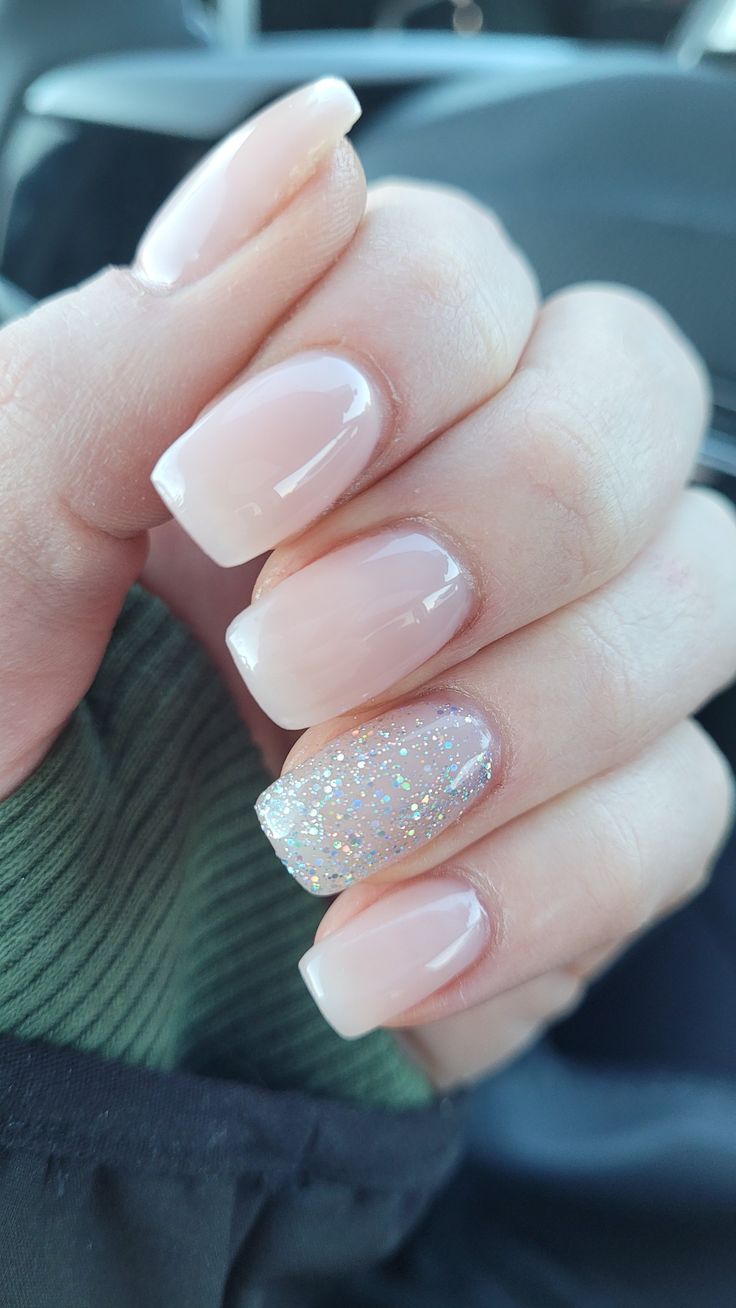 Chic Neutral Nail Design with Glitter Accent for a Sophisticated Glam Look.