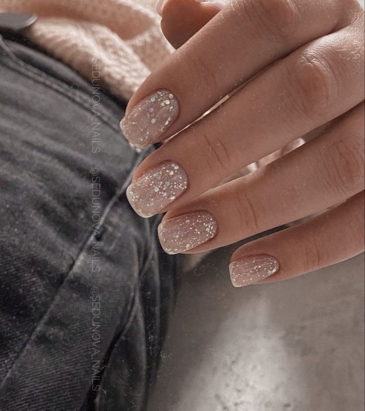 Sophisticated Elegant Nail Design with Soft Pink Hues and Shimmering Glitter Accents.