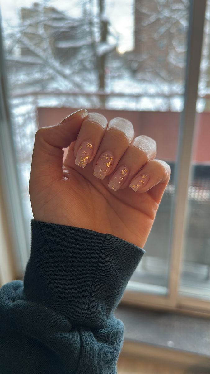 Sophisticated Nude Nails Enhanced with Glamorous Gold Leaf Accents.