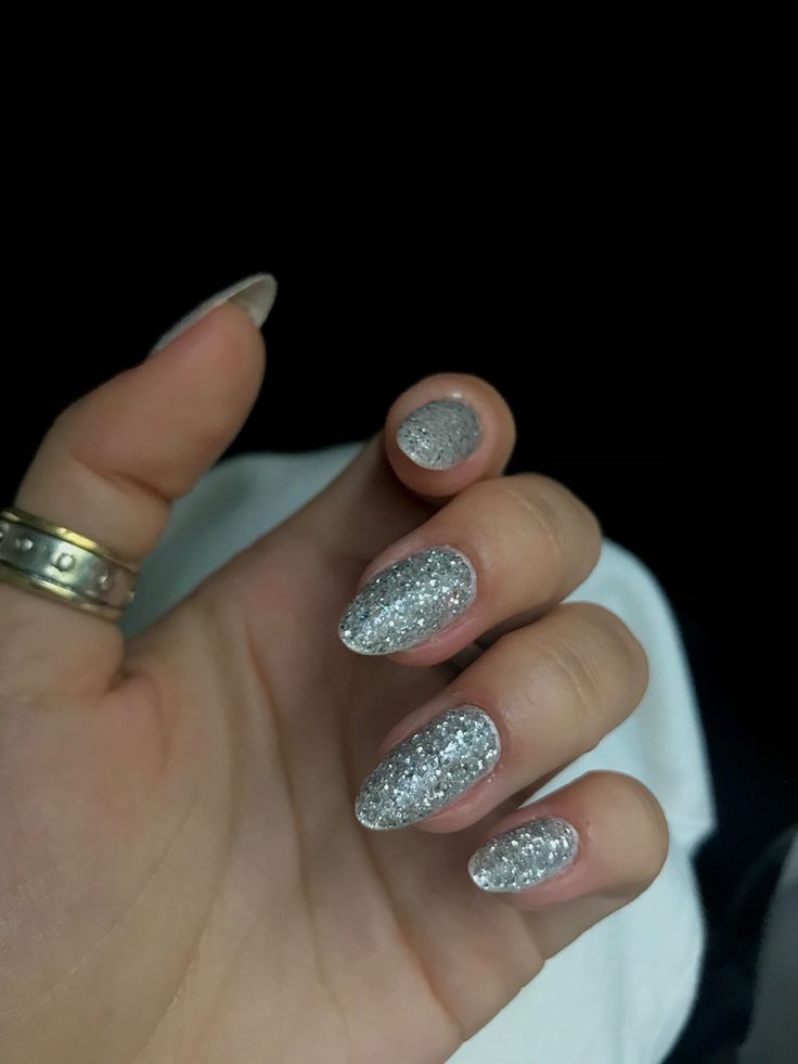 Elegant Glittering Silver Almond Nails for a Sophisticated Glamorous Look.