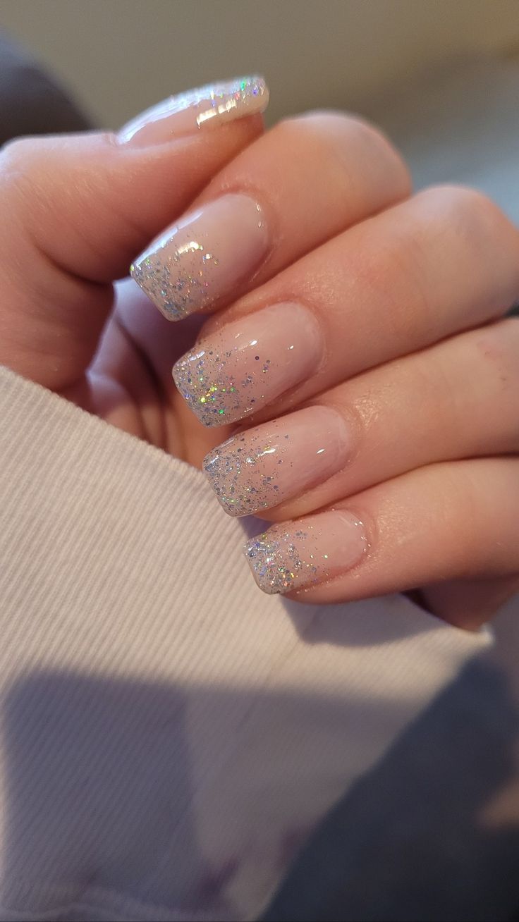 Chic Nude Nail Design with Sparkling Gradient and Glamorous Glitter Tips.