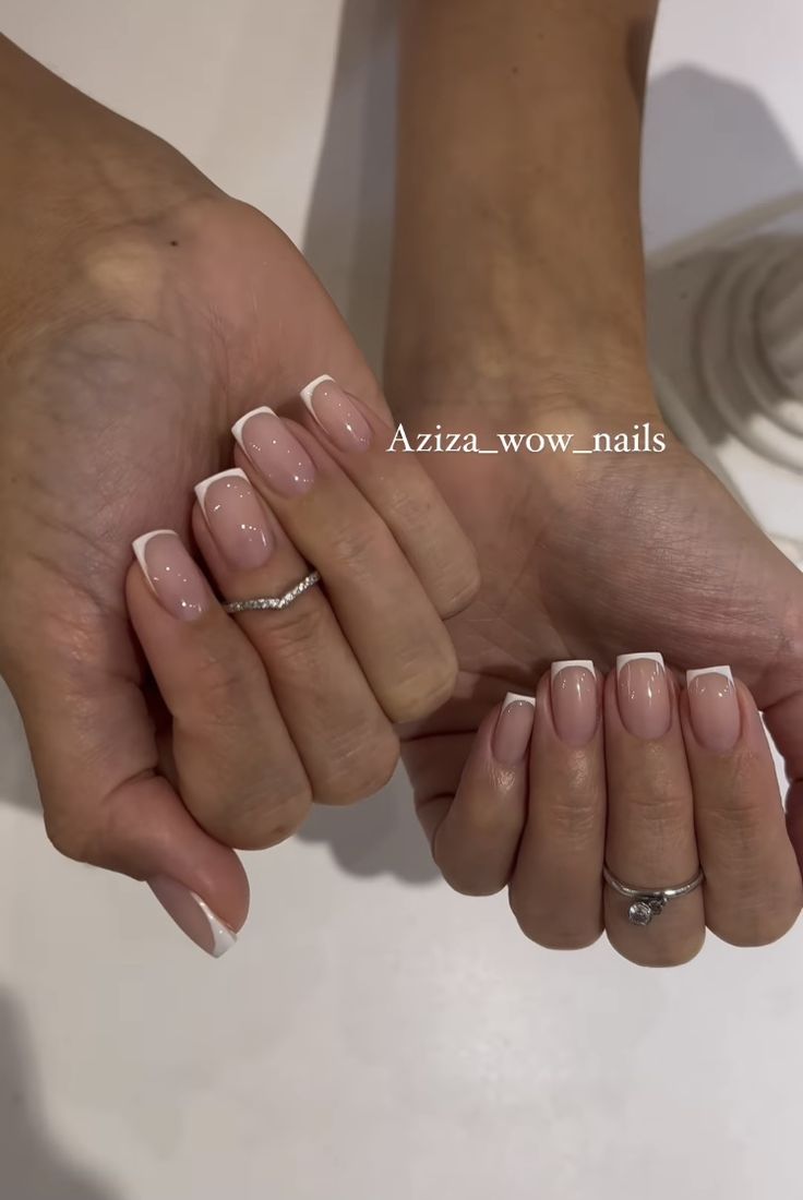 Sophisticated French Manicure: Classic Elegance with a Modern Twist and Delicate Ring Accents.