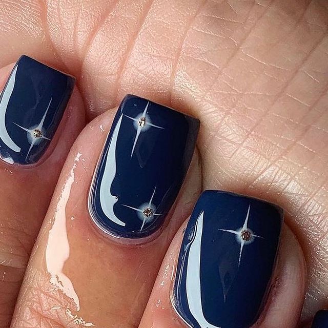 Chic Deep Navy Blue Nail Design with Sparkling Rhinestone Accents for Sophisticated Elegance.