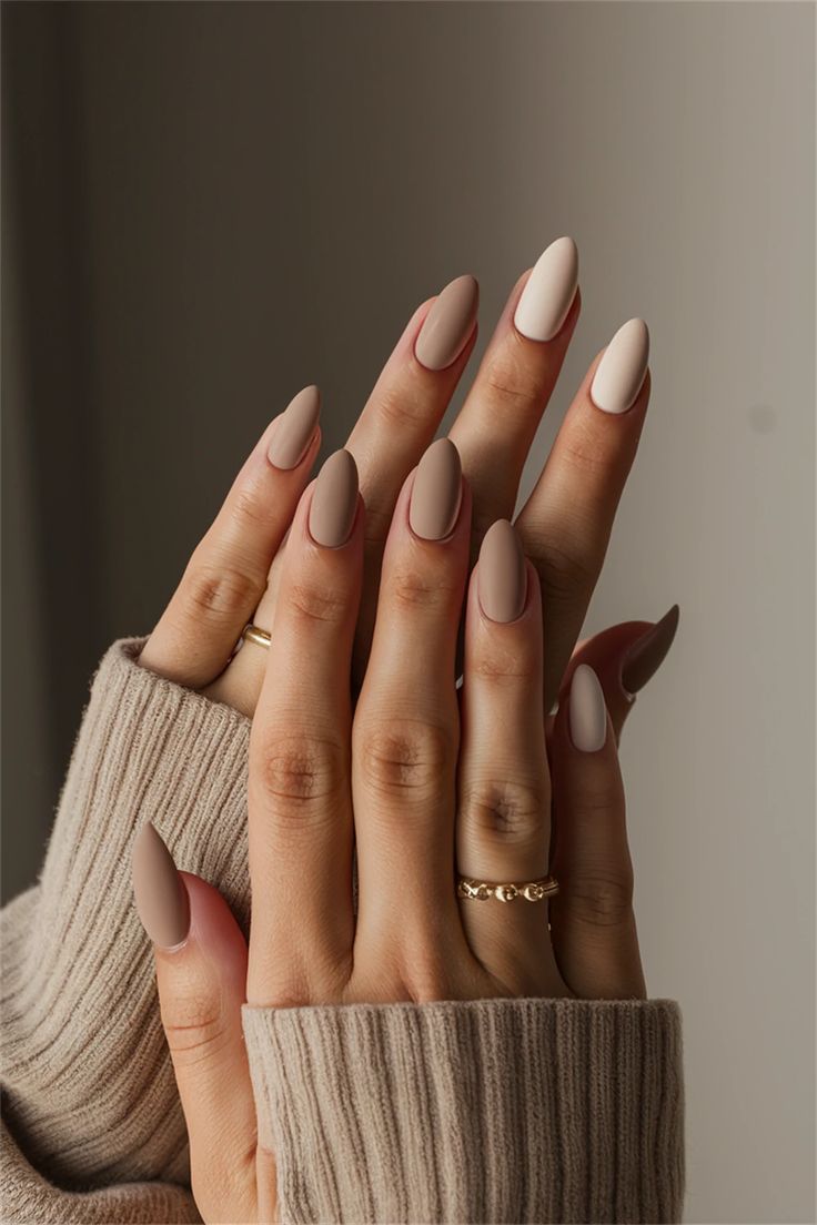 Chic Matte Almond Nails in Neutral Tones with Elegant Golden Accents.