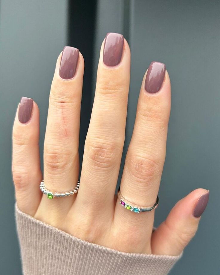 Sophisticated Soft Mauve Nail Design with Minimalistic Rings for Versatile Elegance.