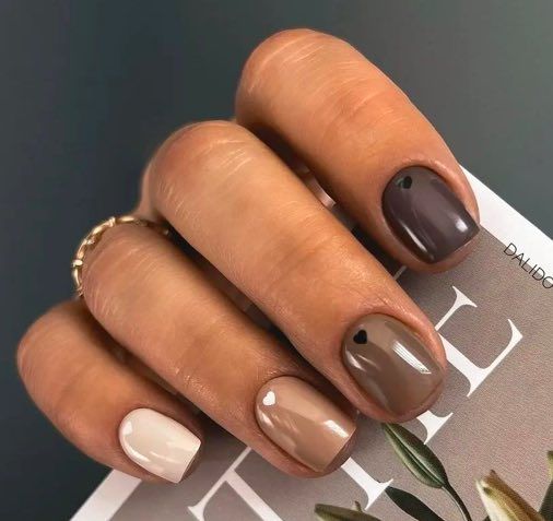 Trendy Earthy Toned Nail Design with Playful Accents.