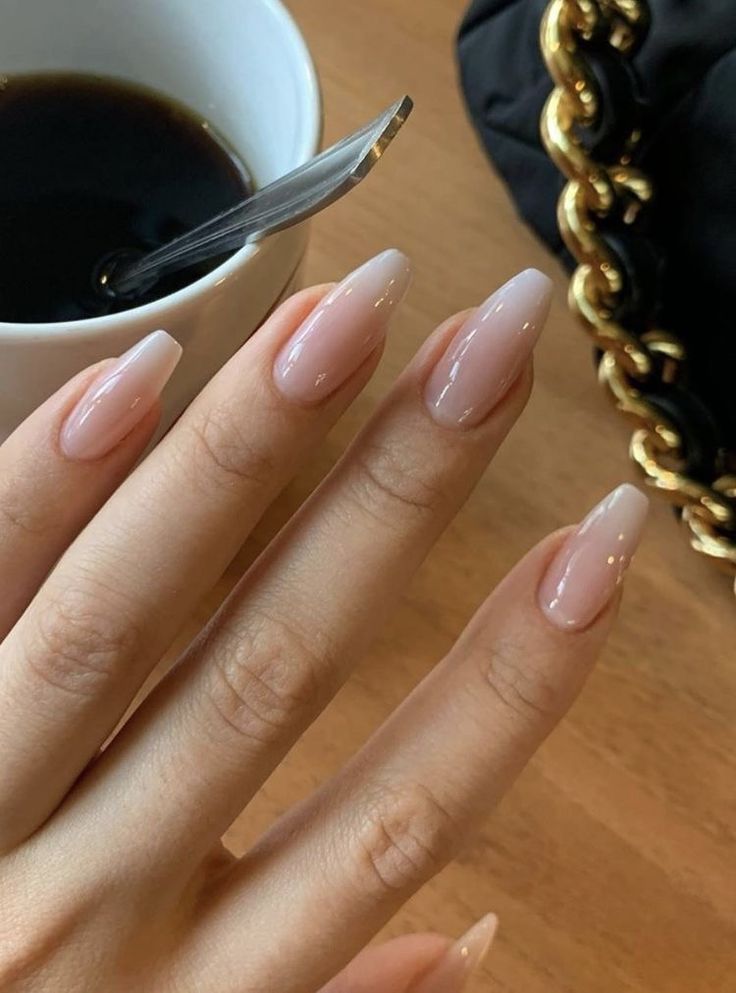 Chic Nude and Pale Pink Ombre Almond Nail Design for Sophisticated Elegance.