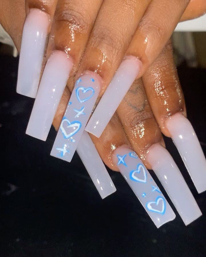 Chic Translucent Long Acrylic Nails with Playful Blue Heart and Star Designs.