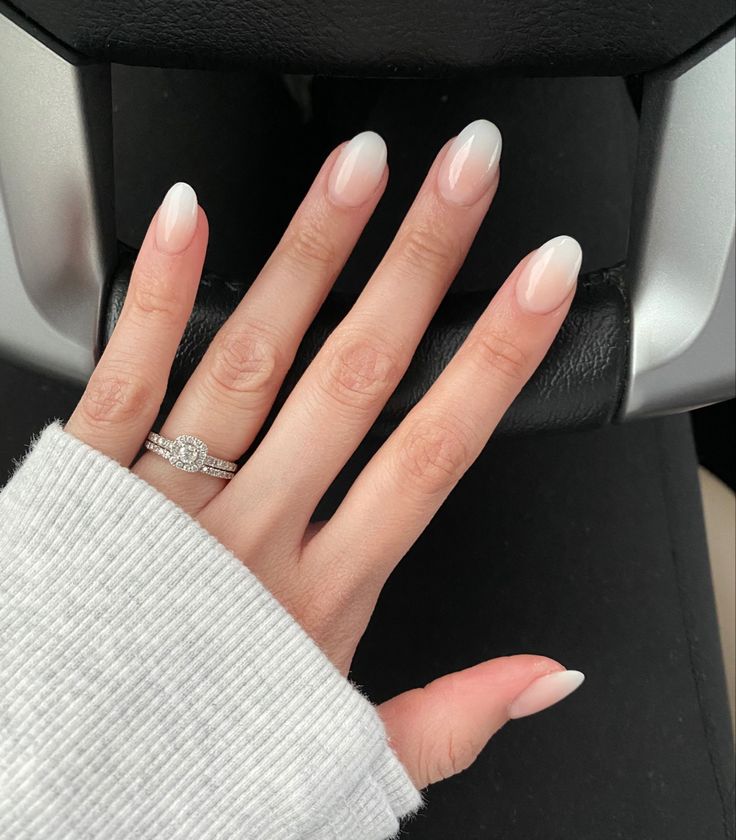 Sophisticated Ombre Nails: Elegant Transition from Pale Pink to Crisp White with Shimmer.