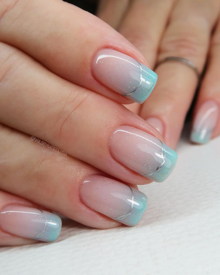 Chic Ombre Nail Design: Light Nude to Delicate Blue with Sparkle and Silver Accent.