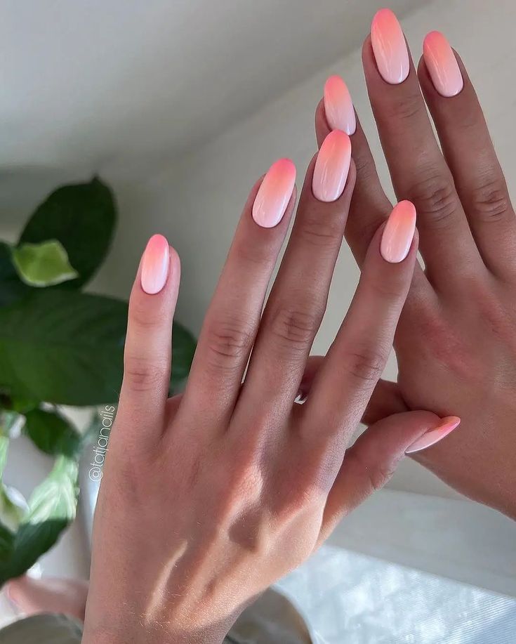 Chic Ombre Nail Design: Elegant Blend of Soft Pink and Coral Hues for Everyday and Special Occasions.