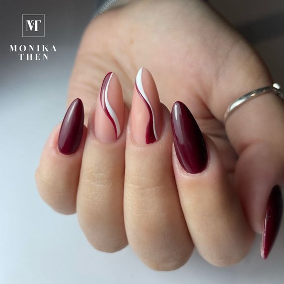 Elegant Almond-Shaped Nail Design: Deep Burgundy and Soft Nude with Bold Stripes for Modern Sophistication.