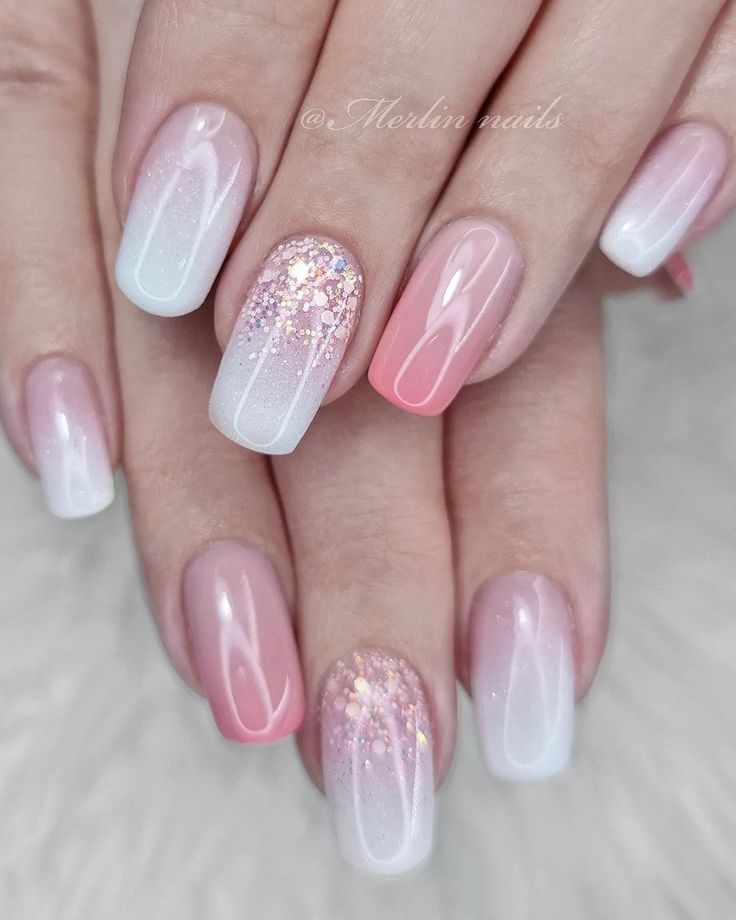 Sophisticated Ombre Nail Design with Pastel Pink and White Hues Enhanced by Glitter Accents.