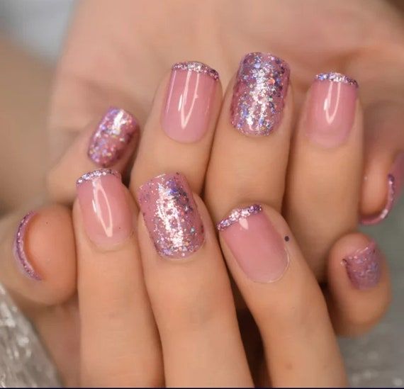 Elegant Ombre Nail Design: Soft Pink and Vibrant Purple with Glittery Finish.