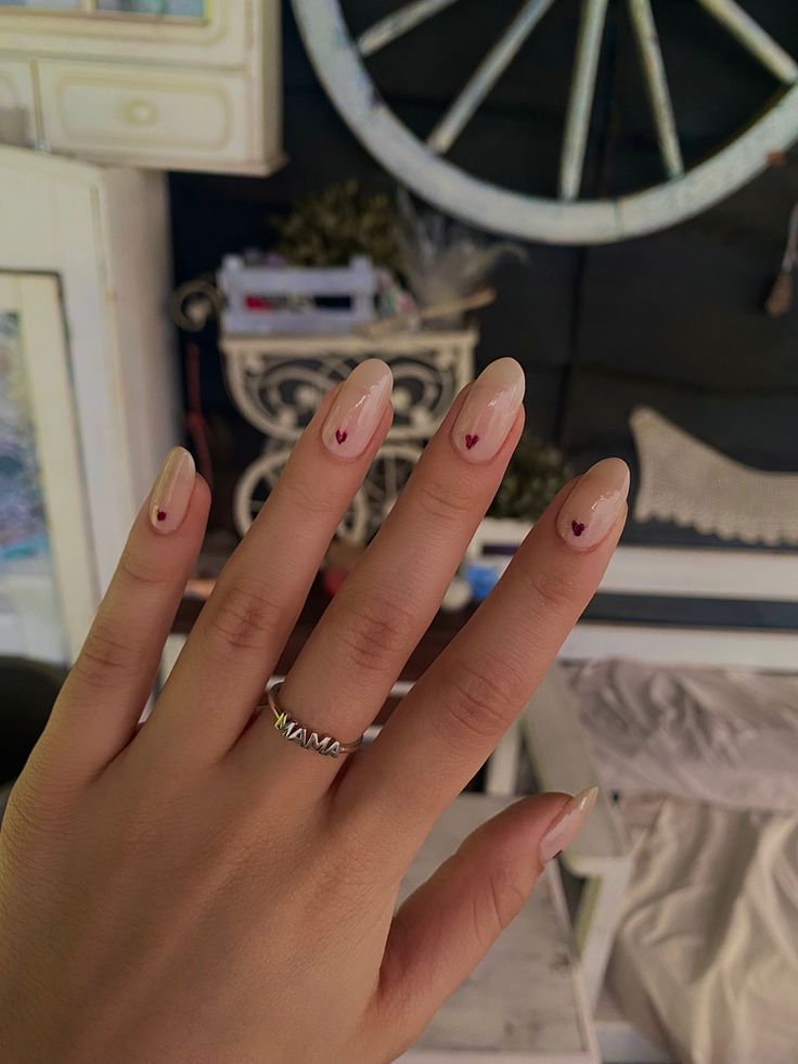 Charming Elegant Nude Nails with Playful Heart Accents