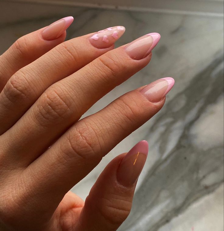 Chic Pink and Nude Nail Design with Heart Accents for Sophisticated Whimsy.