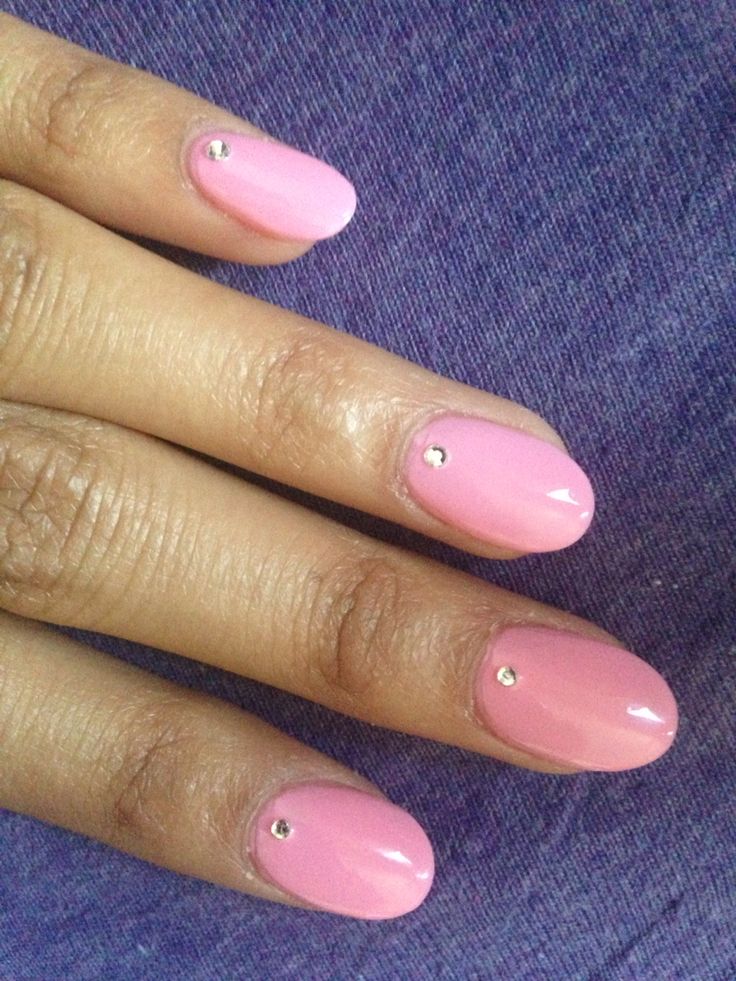 Chic Pink Nail Design with Glossy Finish and Metallic Accents.