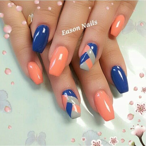 Vibrant Coral and Deep Blue Geometric Nail Art with Gray Accents.