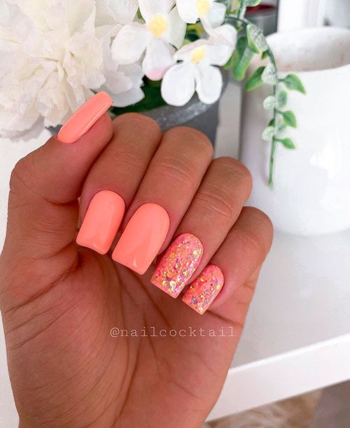 Vibrant Coral Nails: A Cheerful Summer Look with Glossy Colors and Glitter Accents.