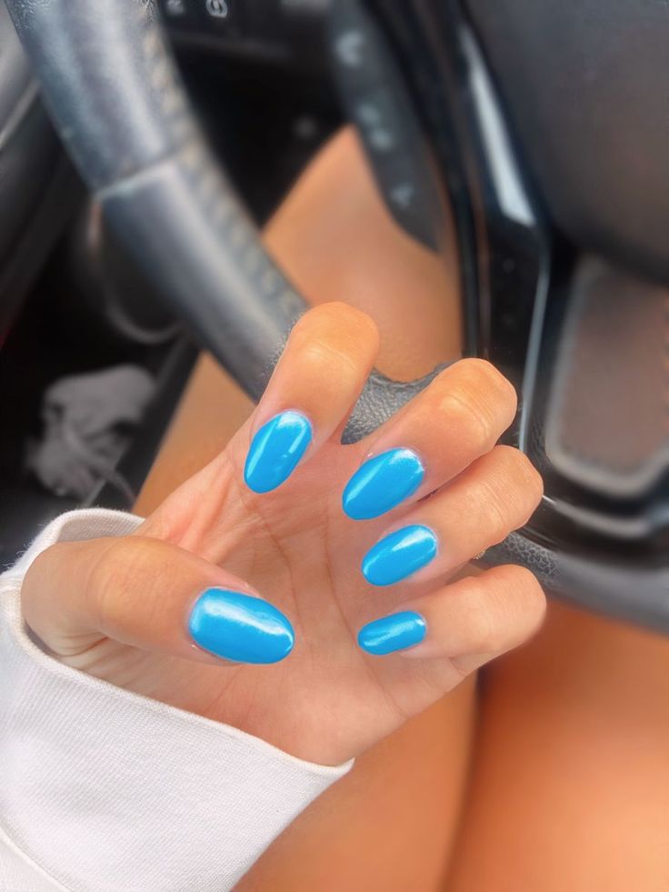 Vibrant Bright Blue Oval Nails: A Cheerful and Versatile Summer Fashion Statement.