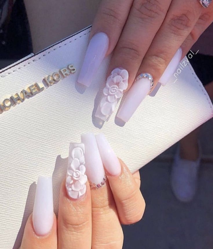 Chic Long Glossy White Nails with 3D Floral Accents and Rhinestones for Elegant Style.