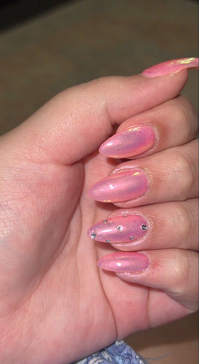 Sophisticated Soft Pink Nail Design with Iridescent Shimmer and Gem Accents.