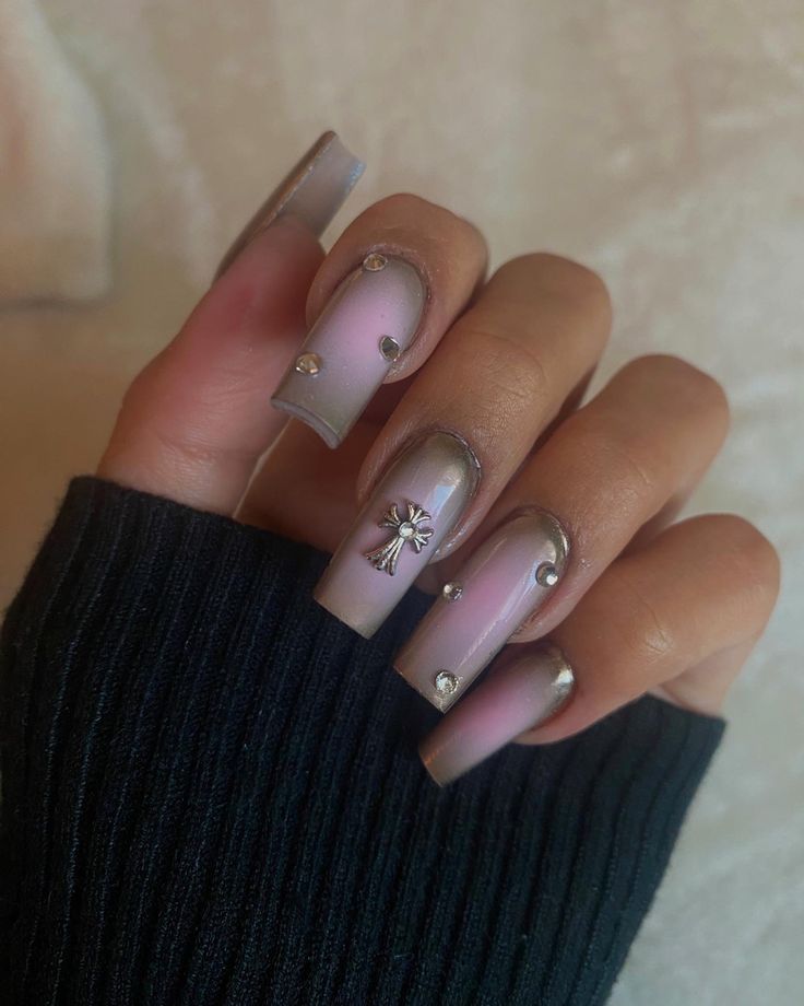 Sophisticated Elegant Nail Design: Soft Pink and Nude with Metallic Tips and Floral Accents.