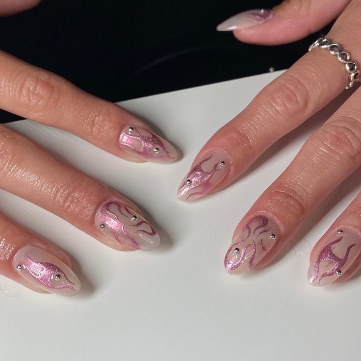 Elegant Intricate Nail Art Featuring Soft Pink Hues and Sparkling Embellishments.