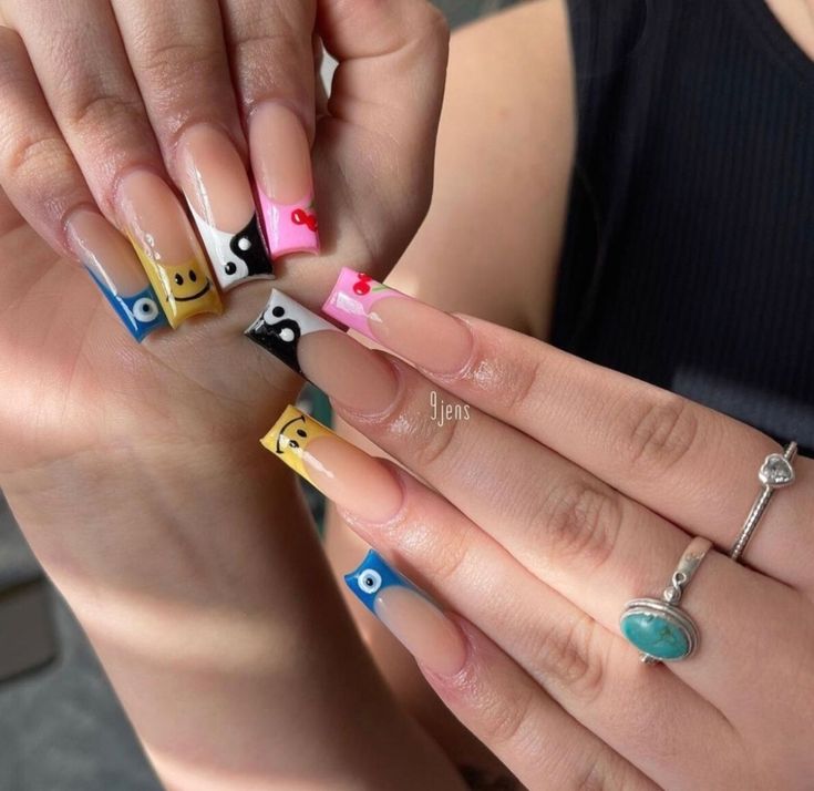 Whimsical Colorful Nail Design with Playful Patterns and Modern French Tips