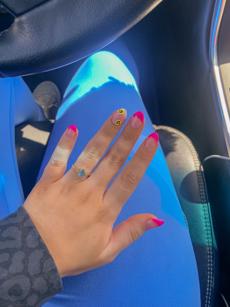 Playful Vibrant Nail Art with Bright Pink, Cheerful Yellow, and a Fun Smiley Accent.