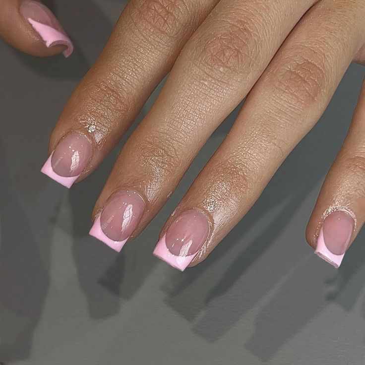 Chic and Playful Pink Glossy Nail Design with Modern French Tips.