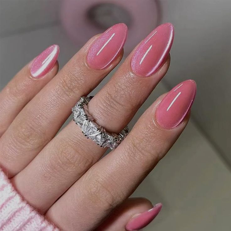 Chic Almond-Shaped Pink Nails with White Accents and Sparkling Ring for Special Occasions.