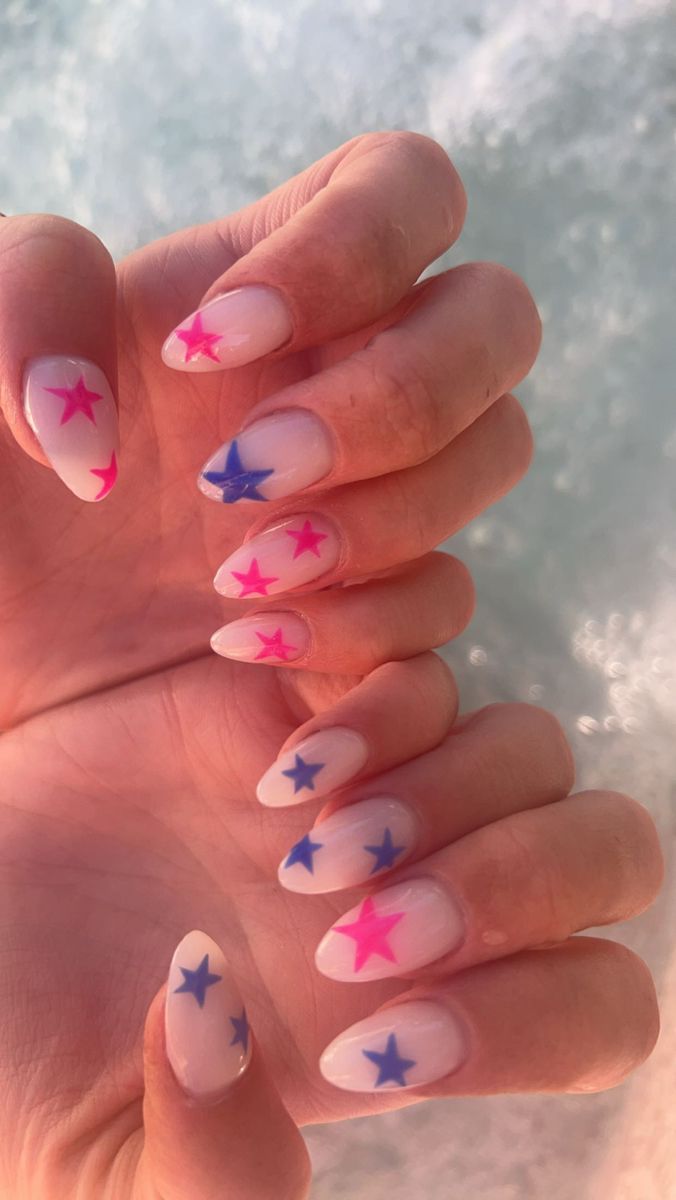 Vibrant Star-Themed Nail Design on Soft Nude Base for Playful Summer Vibes