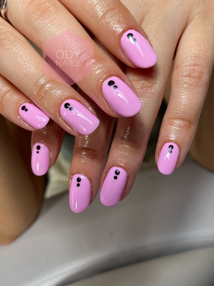 Chic Playful Pink Manicure with Elegant Black Dots