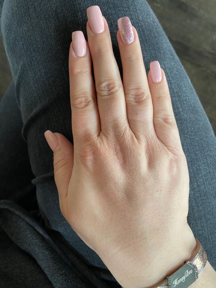 Elegant Nail Design: Soft Pink Polish with Glitter Accent for Versatile Chicness.