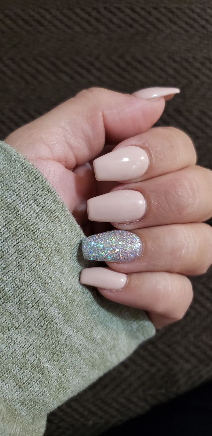 Chic Nude Nail Design with a Single Glitter Accent for Effortless Elegance.