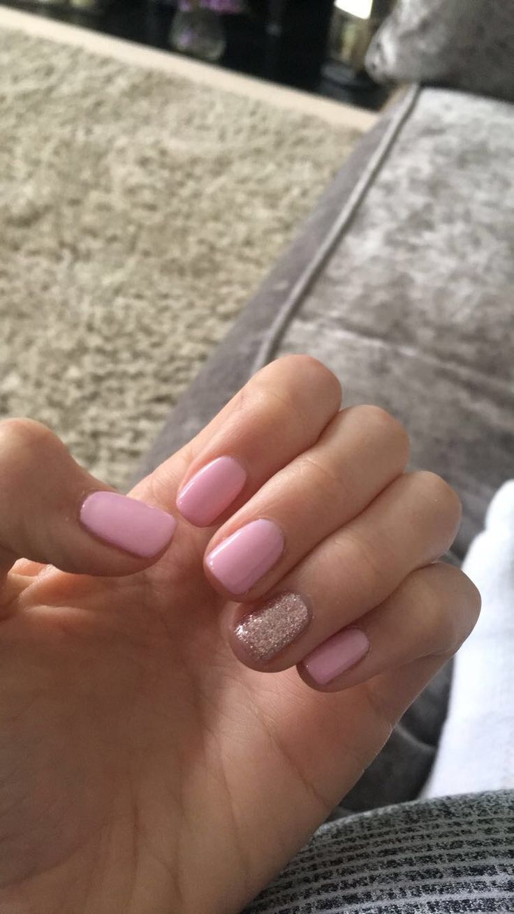 Elegant Pastel Pink Manicure with Glitter Accent for a Playful Touch.