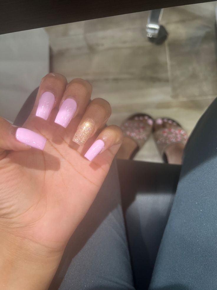 Chic Elegance: Soft Pink Nails with a Shimmering Gold Accent