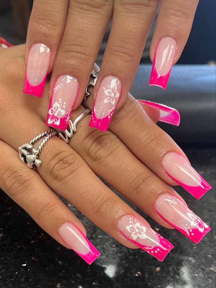 Vibrant Pink French Tip Nail Design with Glossy Finish and Floral Accents.